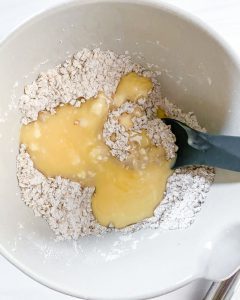 plum crisp ingredients in white bowl in white background