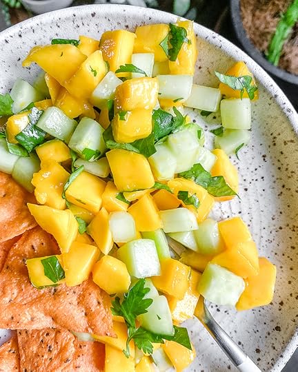 white bowl with mango cucumber salsa in a white background