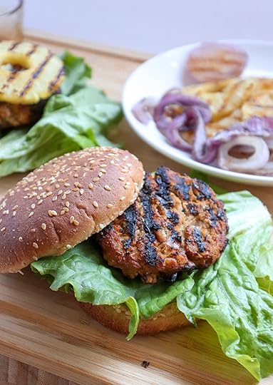 White Bean Teriyaki Burger with various ingredients on plates on a wood surface