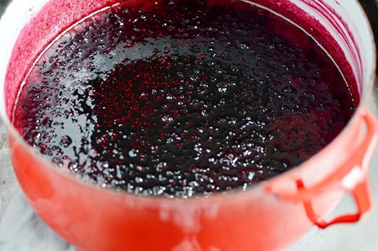 Cooked black raspberry jam in a large, red, vintage Dansk pot.