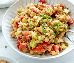 white plate of chickpea salad in a white background