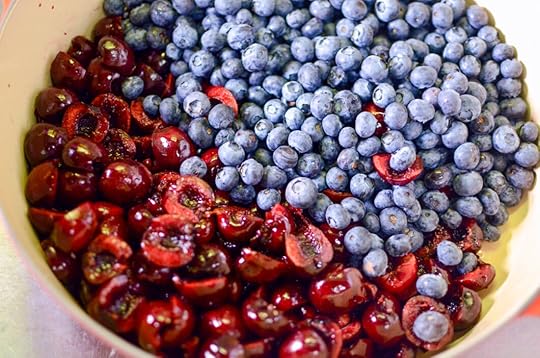 Chopped cherries and blueberries in a pot.