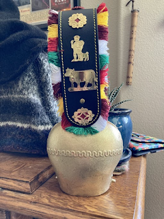 a large golden cowbell on a leather strap