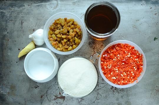 Garlic, ginger, golden raisins, vinegar, chopped peppers, sugar, and salt. These are the ingredients for the chili sauce.