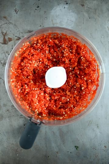 Chopped red peppers in a food processor bowl.