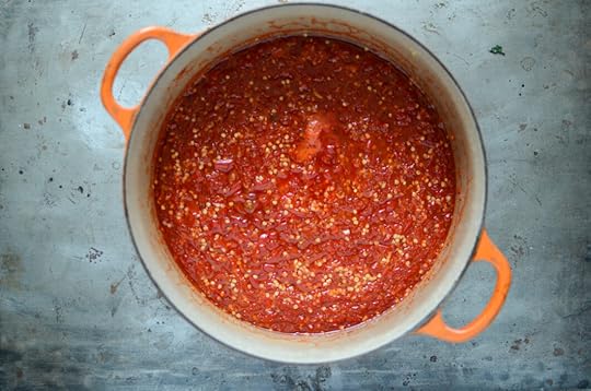 Finished red chili sauce in an orange pot.