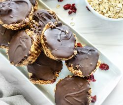 several No-Bake Peanut Butter Cups on a white platter with ingredients in the background