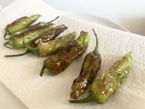 cooked shishito peppers on paper towel