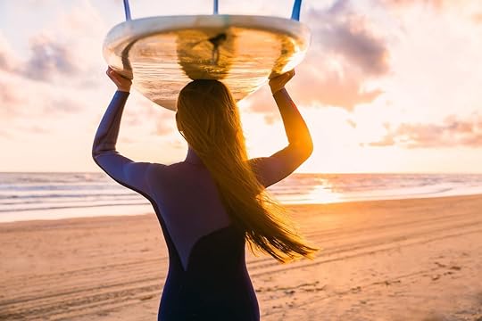 Surf girl with long hair go to surfing. Woman with surfboard on a beach at sunset or sunrise. Surfer and ocean, more sharks