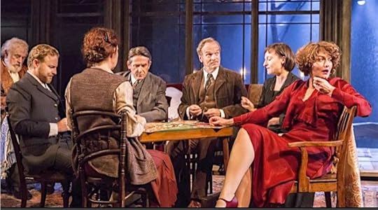 A group of actors wearing early 20th century period costume during a theatre production.