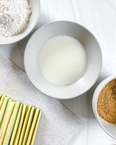 ingredients for Baked Zucchini Fries in a white bowl