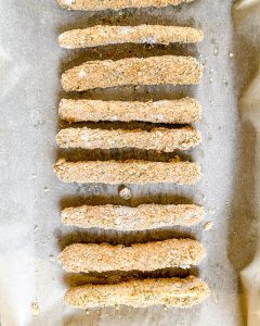 several zucchini fries on parchment paper