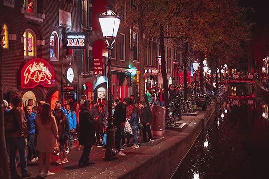 AMSTERDAM,NETHERLANDS-29 APRIL,2019: Crowd of international tourists walking on streets of Red Light District of Amsterdam.Prostitute district - The most popular tourist attraction in Netherlands