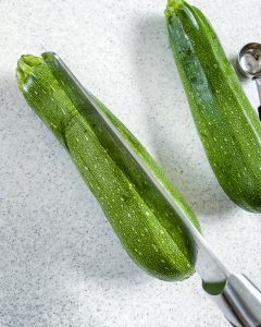 process of making zucchini boats with a white background