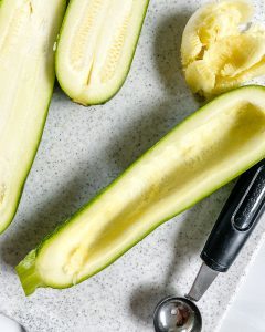 process of making zucchini boats on a white granulated background
