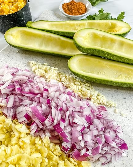 zucchini boats with ingredients in the background