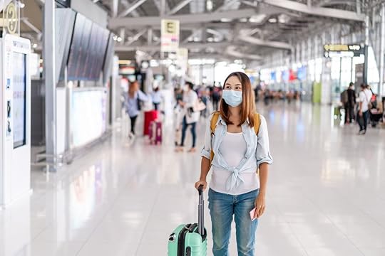 Young,Woman,Wearing,A,Face,Mask,And,Holding,A,Mobile
