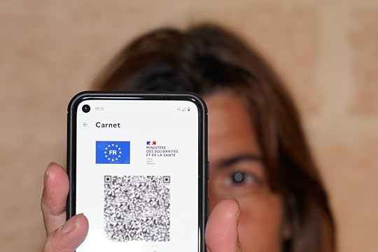 woman holding French Health Pass