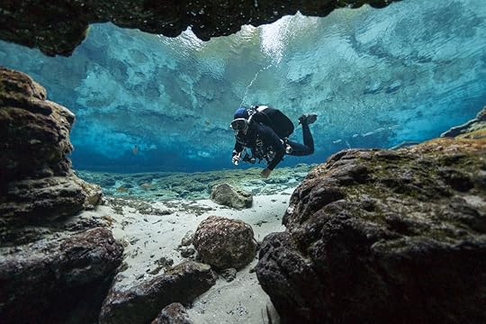 Scuba diver looks into cave at Ginny Springs, Florida