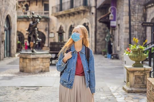 woman in mask walking old european street