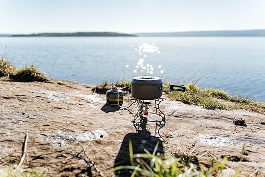 cooking on a gas burner in nature, gas camping stove for cooking food, aluminum pot with lid for trekking, camping equipment for cooking., backpacking food
