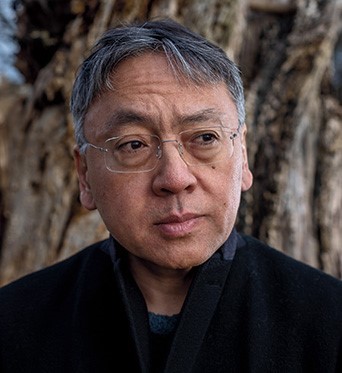 Kazuo Ishiguro, wearing black shirt, looking to his left.