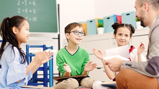 kids clapping their hands for their teacher in school
