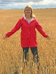 Author Elinor Florence standing in wheat field
