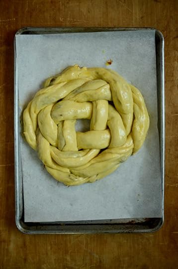An unbaked loaf of filled challah, glazed with egg wash, before the second rise.