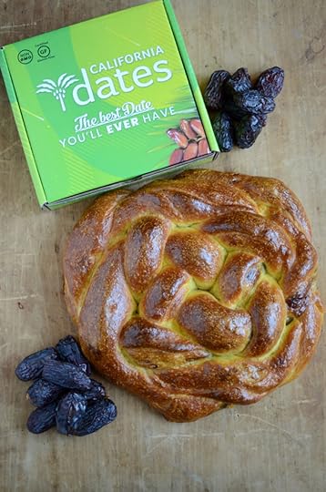 The finished loaf of filled challah, pictured with a green box of California Dates
