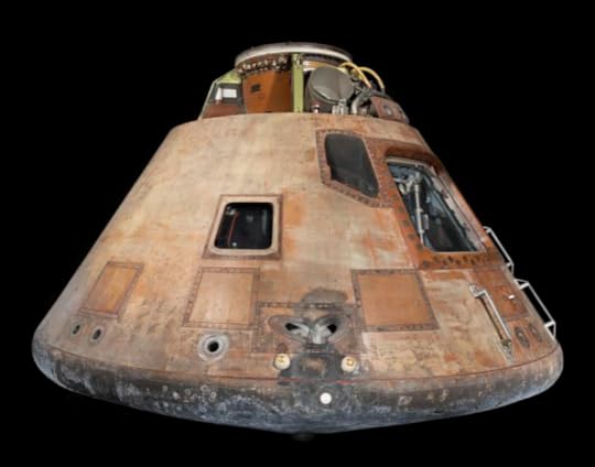 The Apollo 11 command module photographed against a black background.