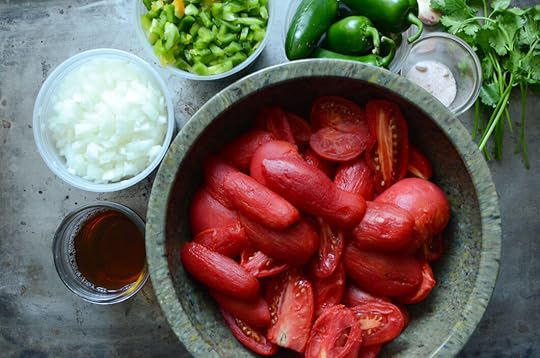Salsa ingredients in containers on a metal baking sheet.