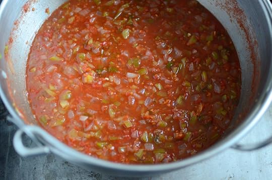 Angled glance at the zesty salsa in a stainless steel pot