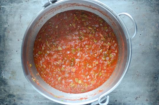 Overhead view of the finished salsa in a stainless steel pot.