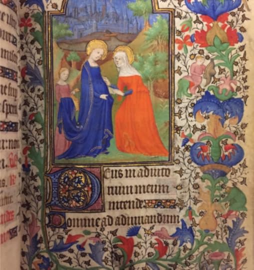 Painted book page depicting two women in flowing robes, one in orange and one in blue, surrounded by an intricate border of blue, red and pink flowers and green vines.