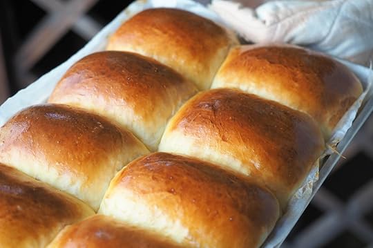 Milk bread chinese bakeries hand holding hot baking tray of bread rolls