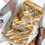four slices of lemon poppy seed cake on a white plate with a bowl and napkin on the side