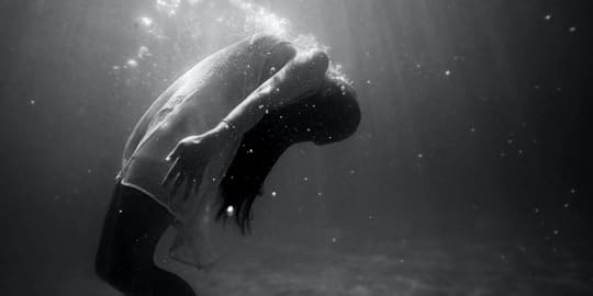 Photo by Christopher Campbell | Black and white photograph of woman floating in water