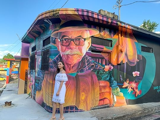Young woman in front of street art in Puerto Rico