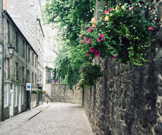 writerly places, a cobbled street with flowers
