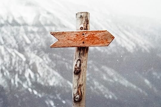 Image: directional wooden signpost with no words on it.