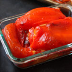 roasted red peppers in glass storage container.