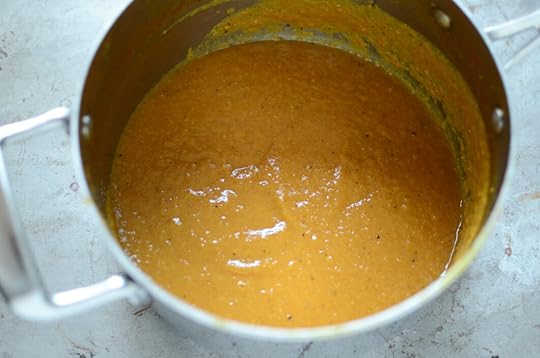 Pureed banana ketchup in a saucepan on a metal sheet pan.