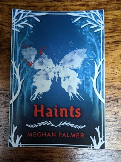 blue background with white, abstract butterfly and white tree outlines. The title and author are printed in red text.