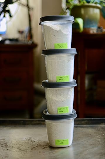 Four plastic freezer containers filled with homemade pancake mix.