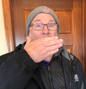 Man holding hand over his mouth