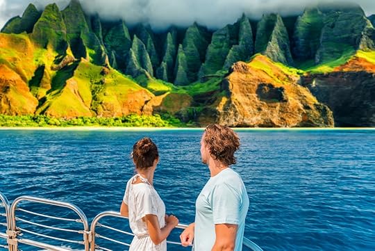 Hawaii Kauai Na Pali coast landscape scenic cruise. Couple watching dramatic mountains famous tourist destination on boat deck. Cruise ship on summer travel vacation and woman tourists relaxing.