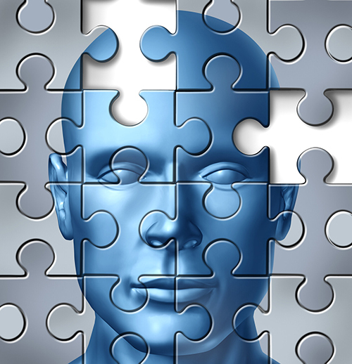 An graphic showing a blue human face against a gray background with the outlines of a jigsaw puzzle across the whole graphic. One puzzle piece is missing. The multiple deficit model of dyslexia means looking for potential multiple contributing factors to dyslexia.
