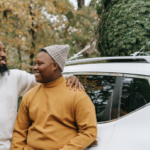 An African-American father embraces his teenage son