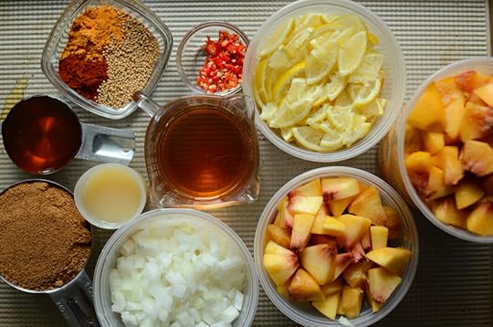 Chutney ingredients on a sheet pan. Chopped peaches, onions, lemons, chilies, apple cider vinegar, coconut sugar, honey, lemon juice, and spices.